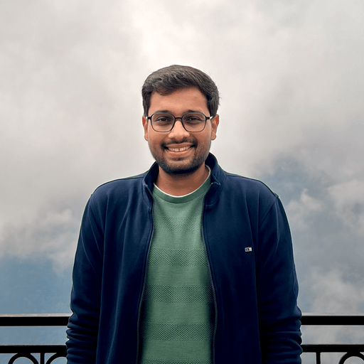 Chaitanya Deorukhkar smiling in front of misty mountains